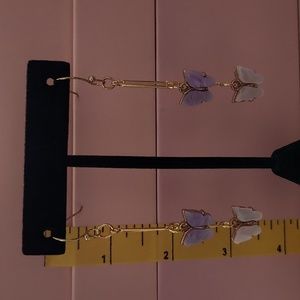 Gold tone butterfly drop earrings.